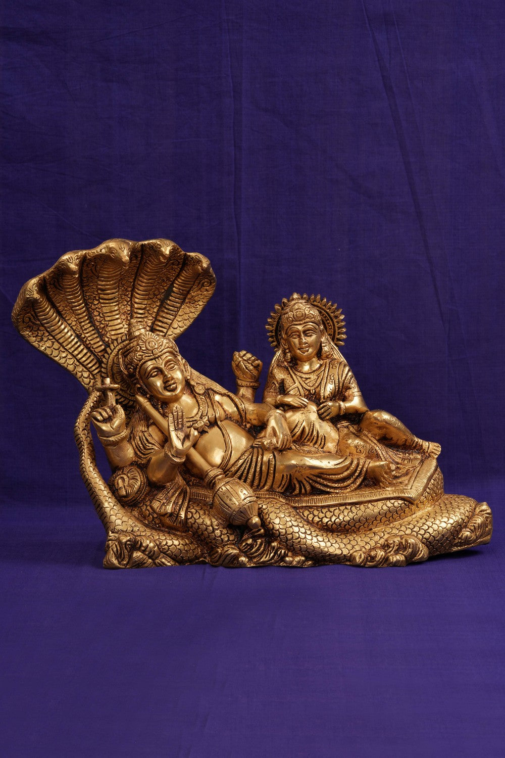Brass Lord Vishnu and Goddess Lakshmi reclining on the serpent Sesha Naga.