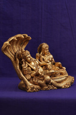 Image of Brass Lord Vishnu and Goddess Lakshmi reclining on the serpent Sesha Naga.