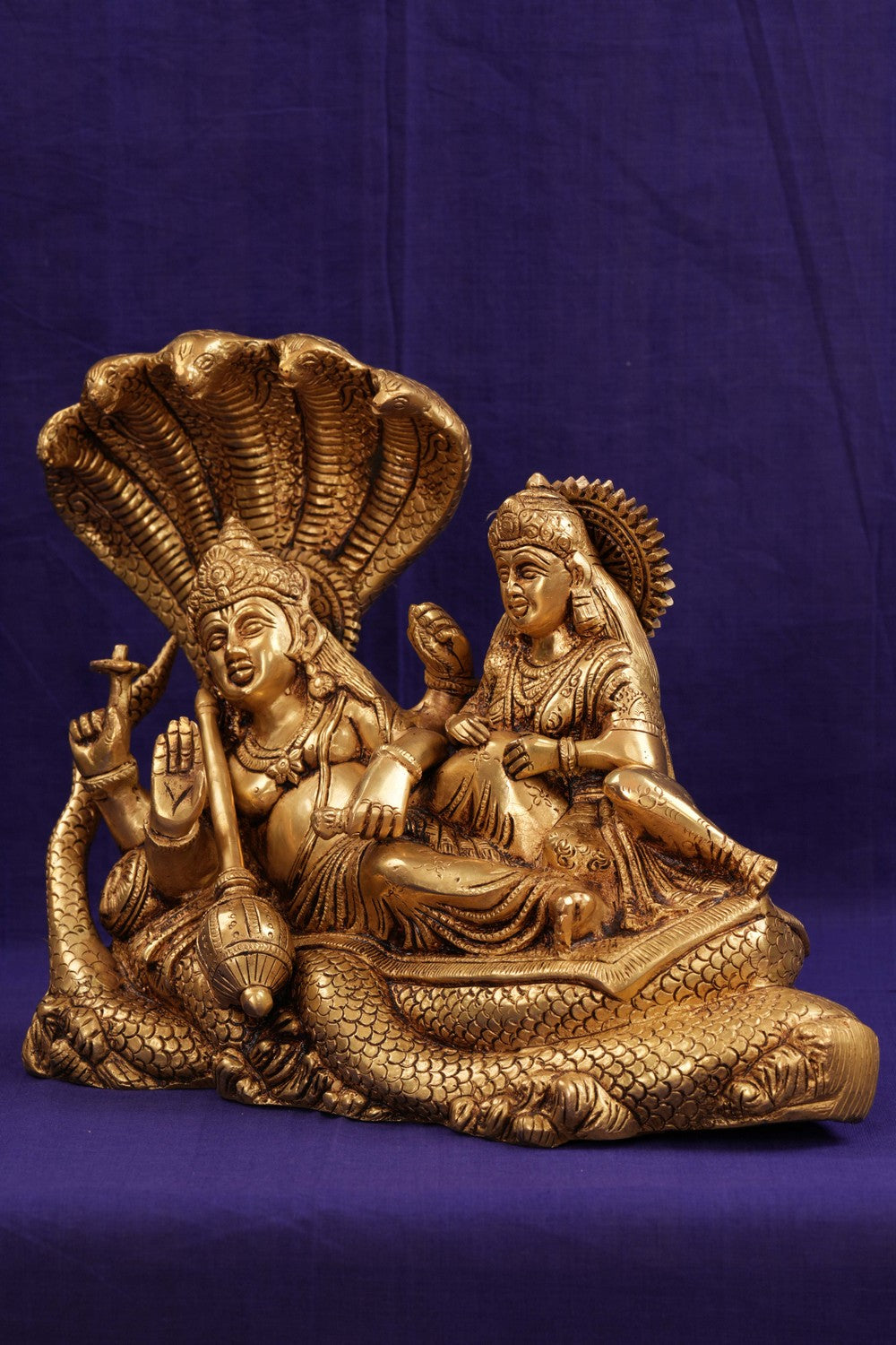 Brass Lord Vishnu and Goddess Lakshmi reclining on the serpent Sesha Naga.