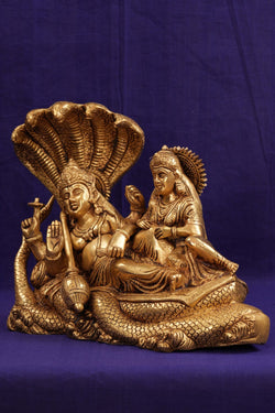Image of Brass Lord Vishnu and Goddess Lakshmi reclining on the serpent Sesha Naga.