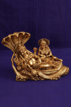 Image of Brass Lord Vishnu and Goddess Lakshmi reclining on the serpent Sesha Naga.