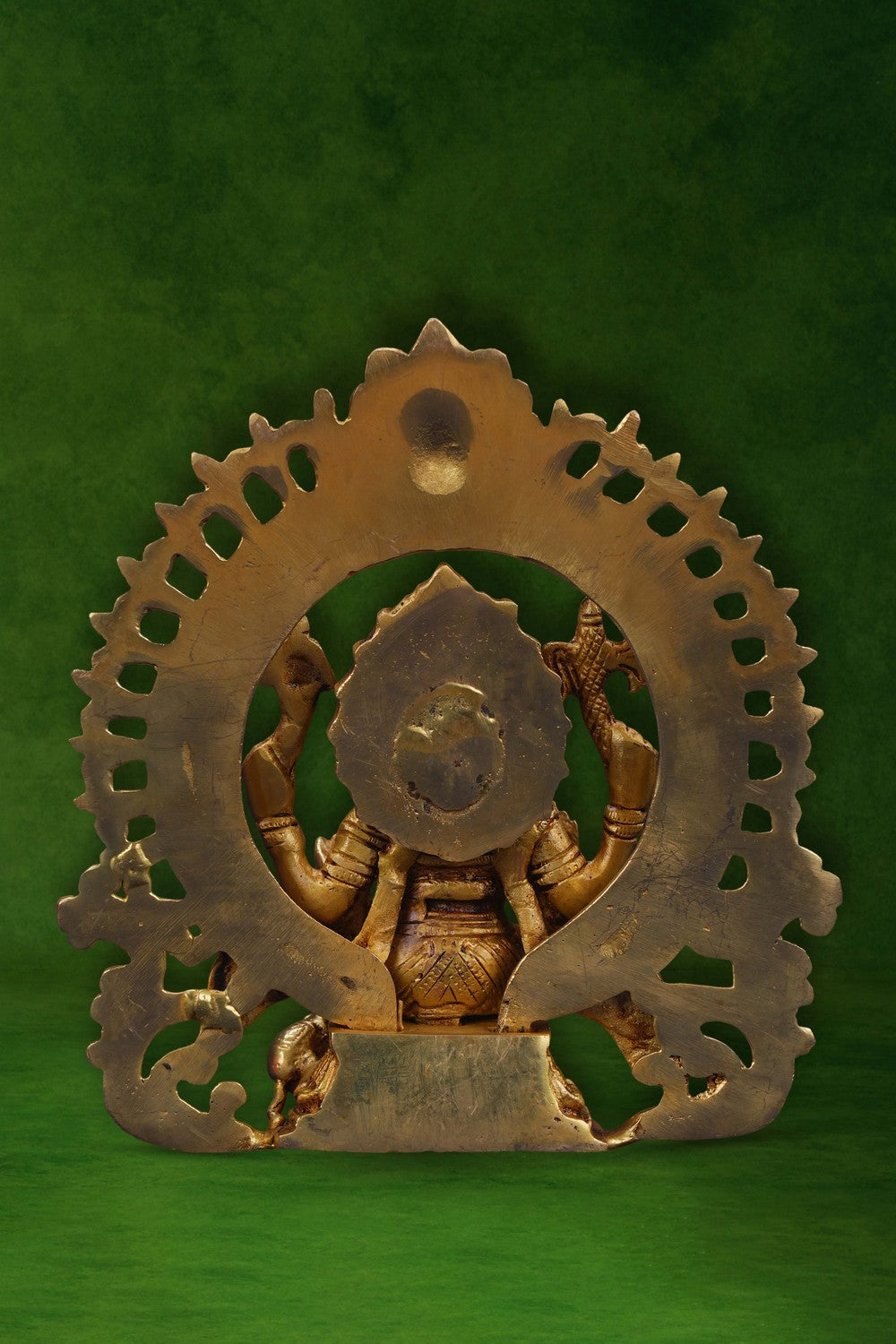 Image of A brass Ganesha idol in a sitting posture