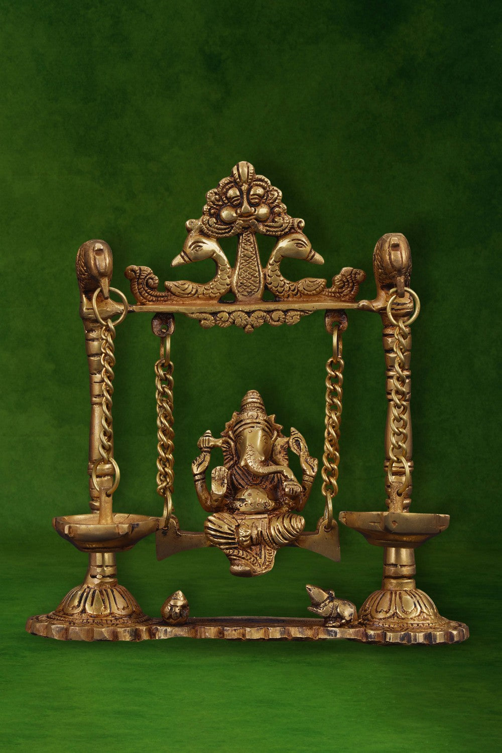 Image of Ganesh statue hanging a brass diya with peacocks