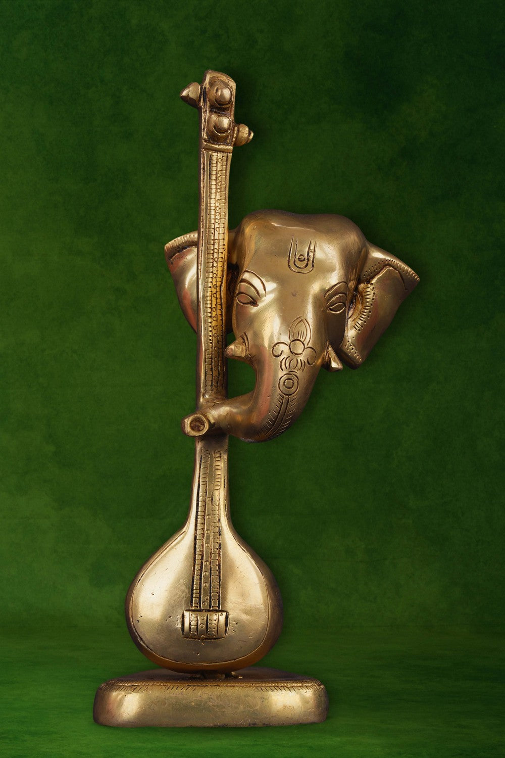 Image of A brass Ganapati face with a veena in modern art