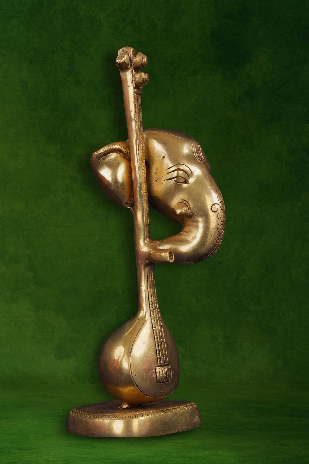 Image of A brass Ganapati face with a veena in modern art