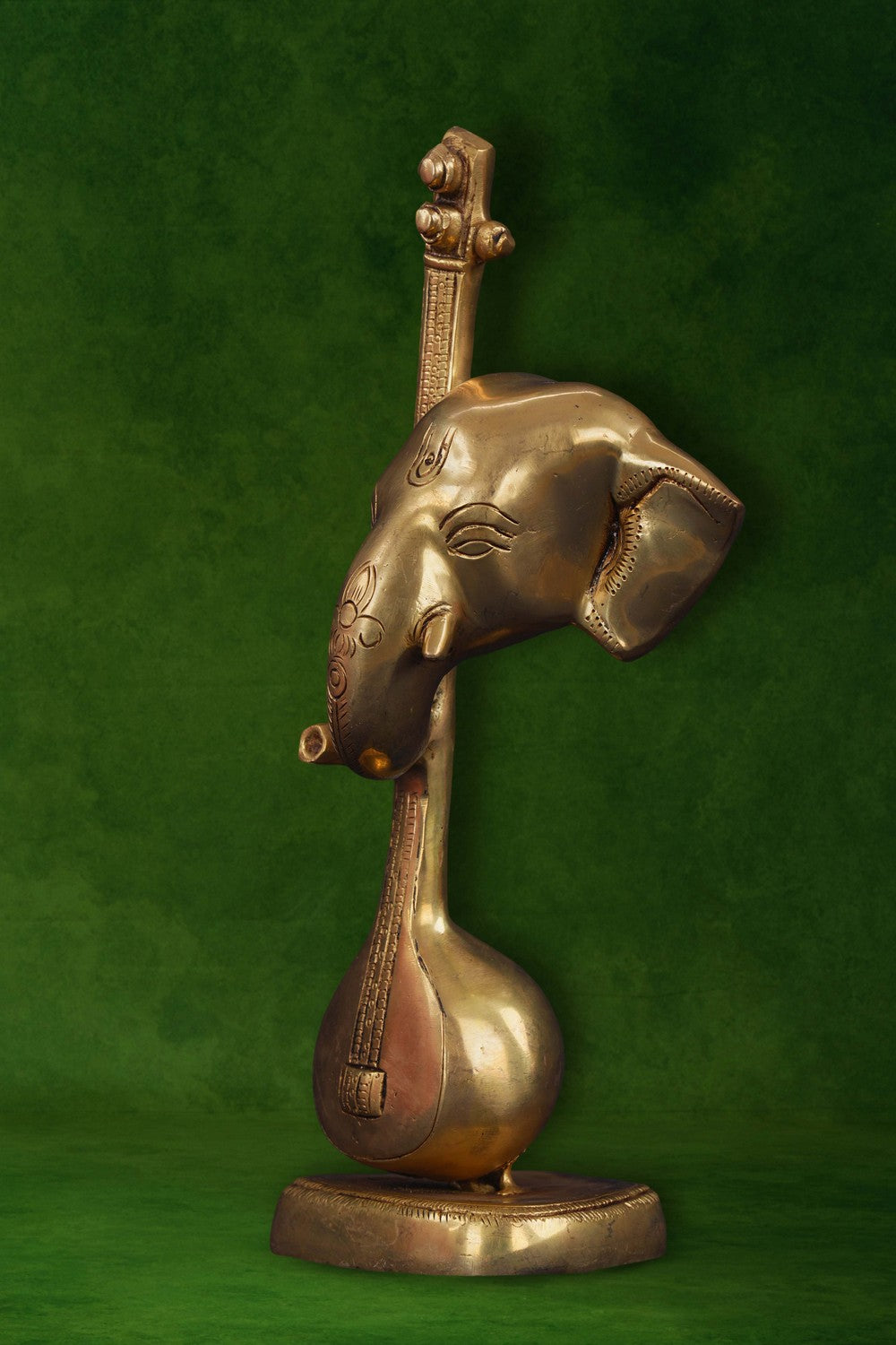 Image of A brass Ganapati face with a veena in modern art