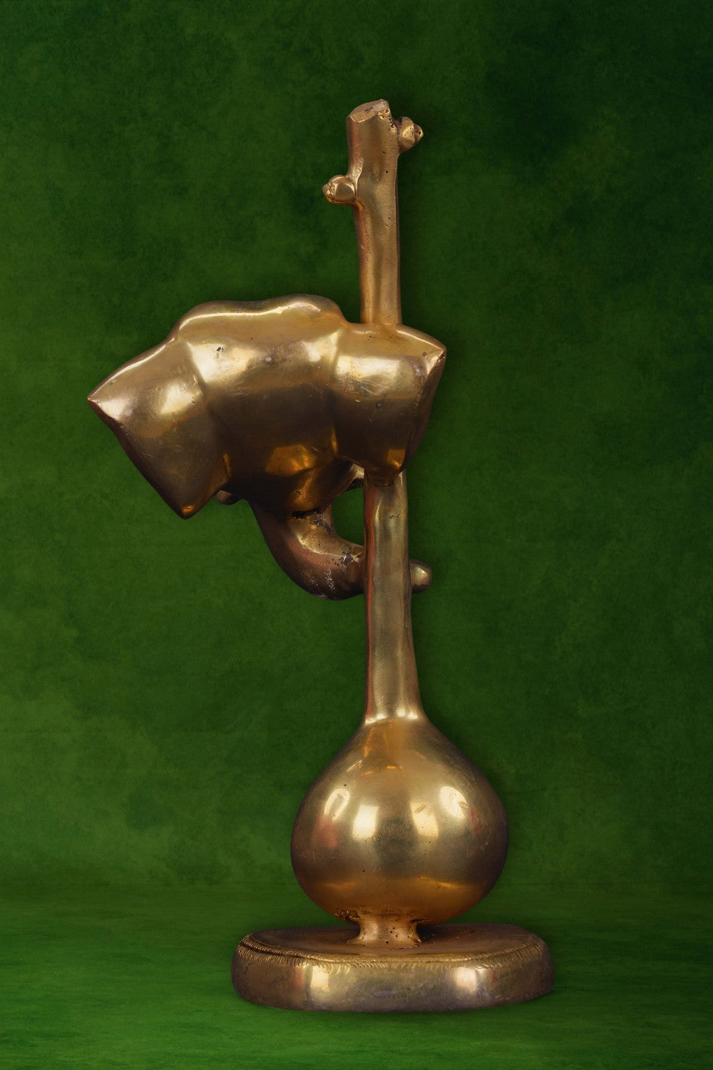 Image of A brass Ganapati face with a veena in modern art
