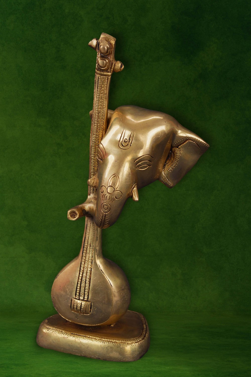 Image of A brass Ganapati face with a veena in modern art