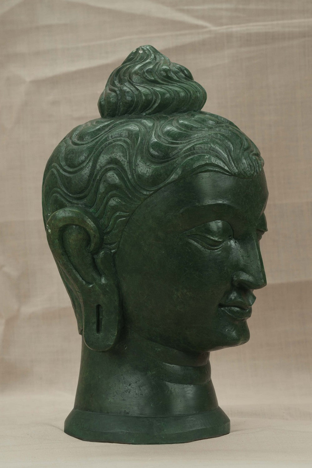 Image of A Green-painted Serpent Stone Buddha Face