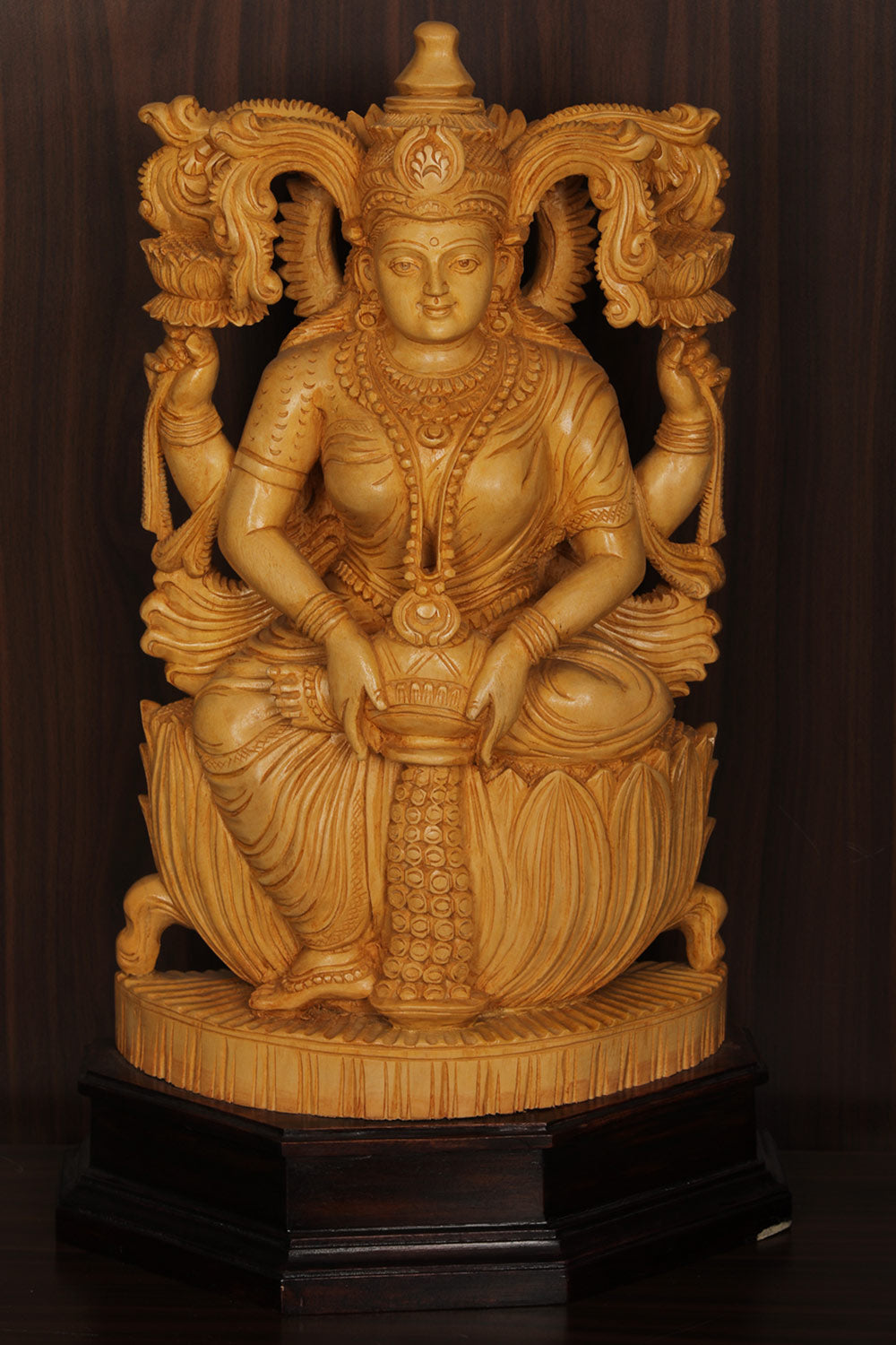 Collection of Shutters Wood Goddess Dhana Lakshmi Idol in a gallery layout