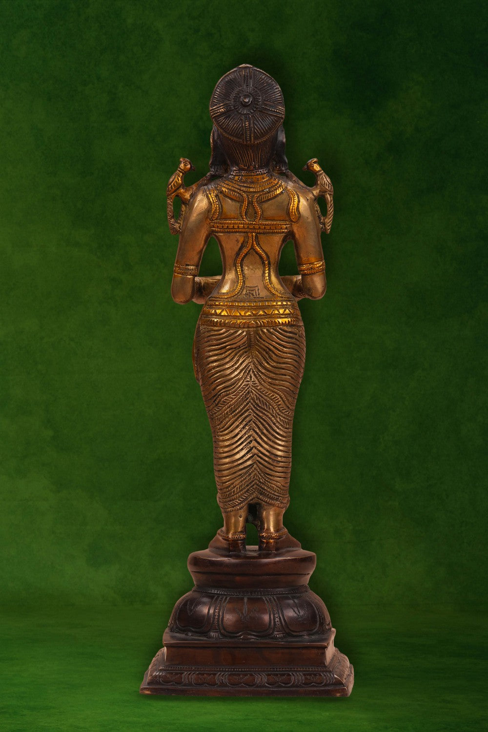 Image of A brass and copper woman holding a diya