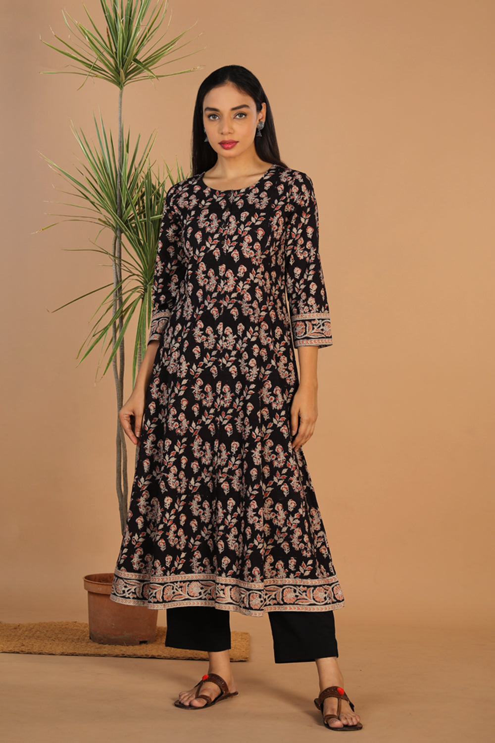 Collection of Charcoal black floral cotton Kalamkari kurti in a gallery layout