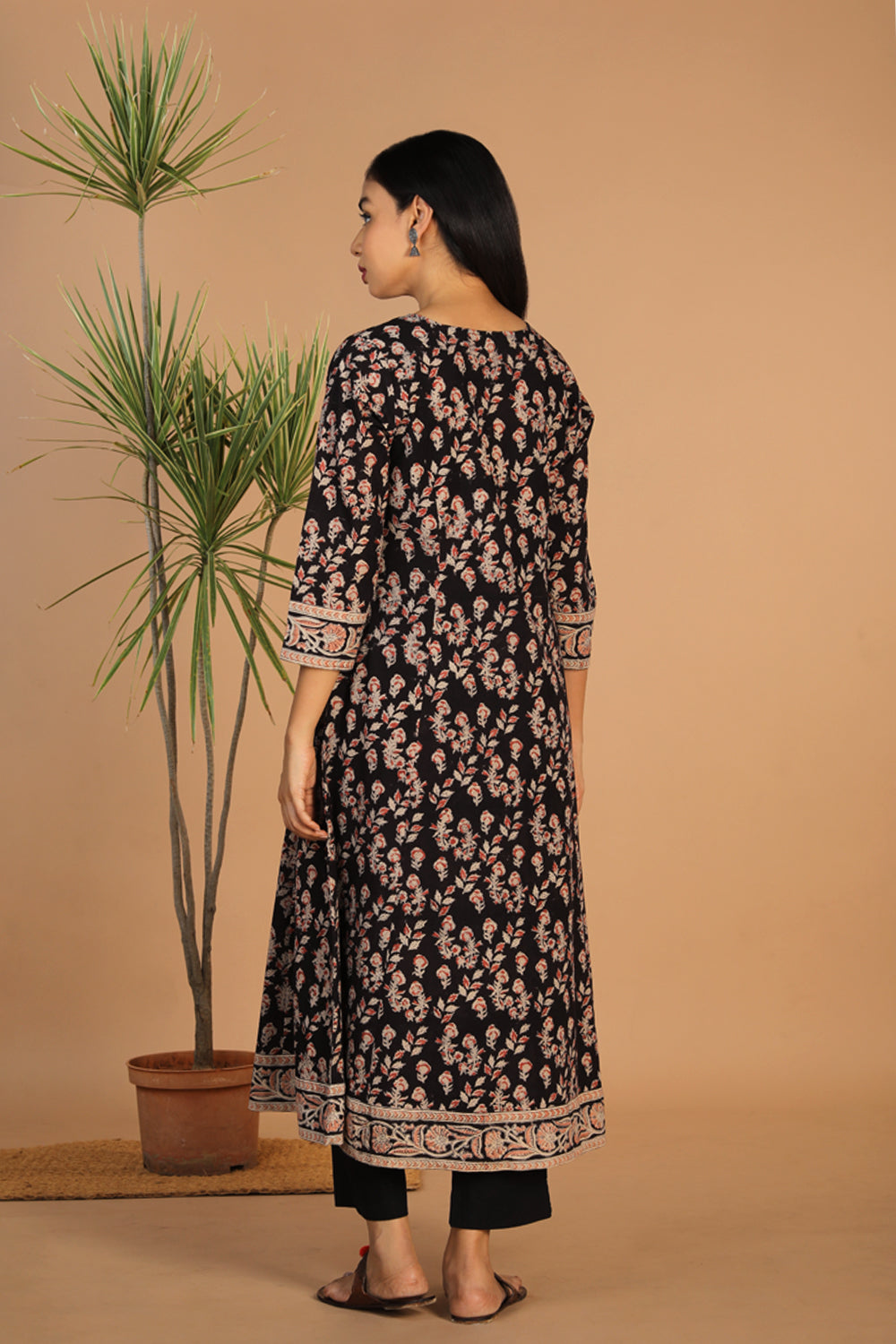 Collection of Charcoal black floral cotton Kalamkari kurti in a gallery layout