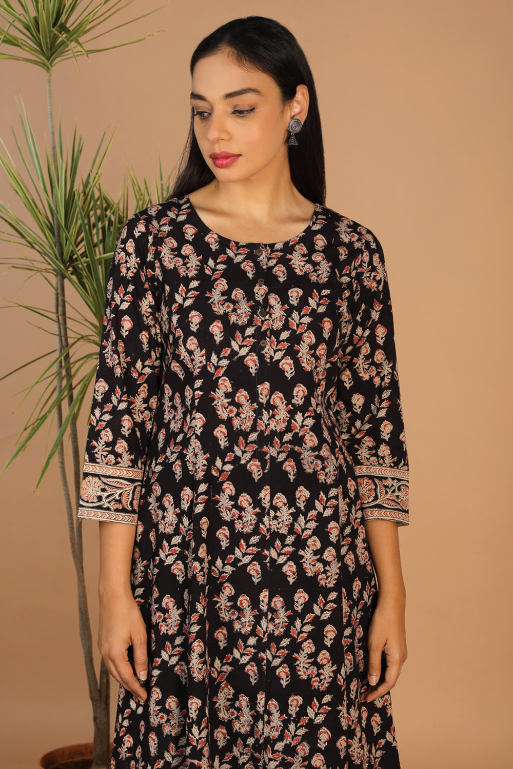 Collection of Charcoal black floral cotton Kalamkari kurti in a gallery layout