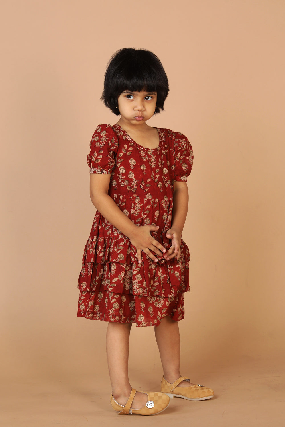 Collection of Maroon kalamkari hand block printed girls frock. in a gallery layout