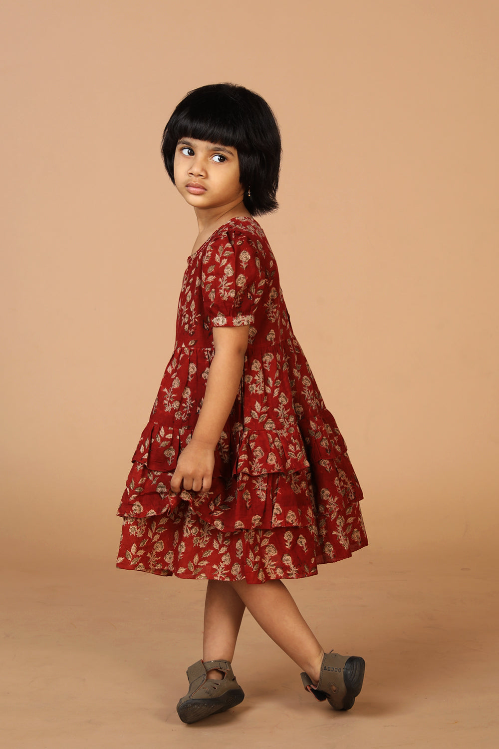 Collection of Maroon kalamkari hand block printed girls frock. in a gallery layout