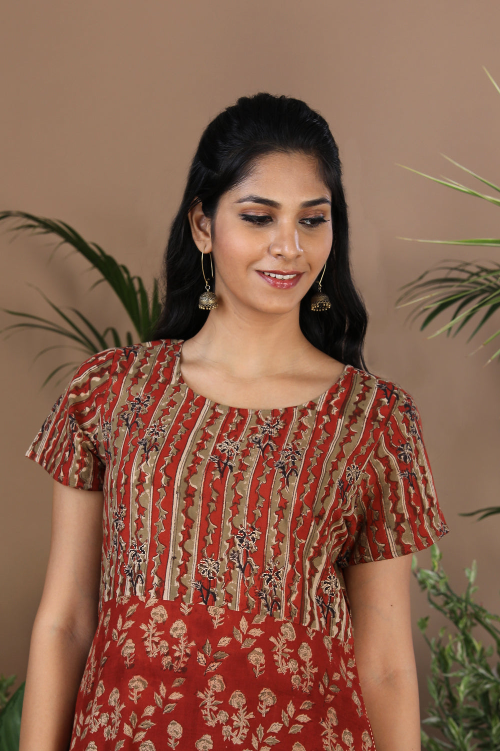 Collection of Maroon floral Kalamkari handblockprinted kurti in a gallery layout