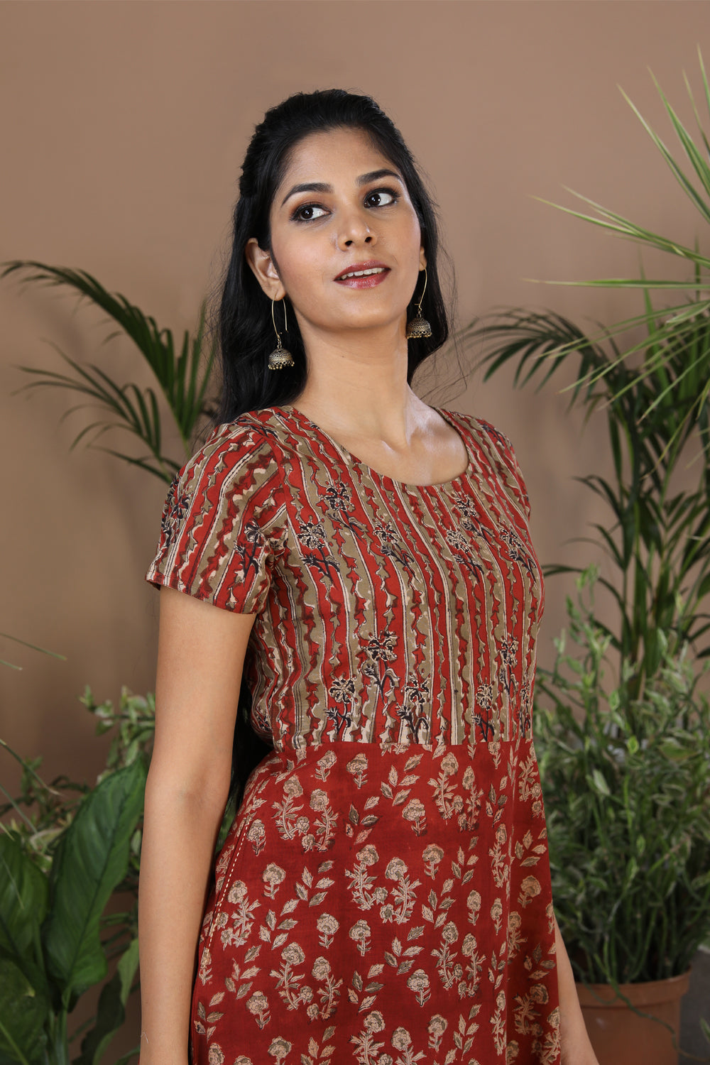 Collection of Maroon floral Kalamkari handblockprinted kurti in a gallery layout