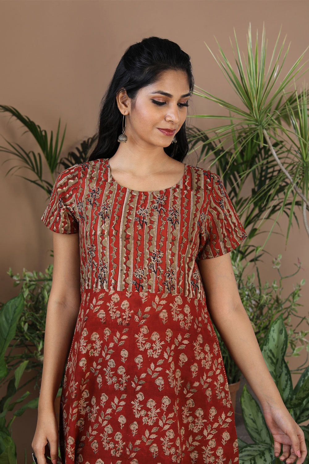 Collection of Maroon floral Kalamkari handblockprinted kurti in a gallery layout